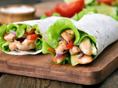 Wrap sandwiches with chicken meat and fresh vegetables, close up view